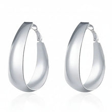 Silver hoop earrings on a white background with 'Doteffil' branding.