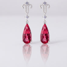 Color-changing teardrop earrings with Atta Gems branding on a white background.