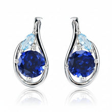 Silver earrings with blue gemstones on a white background, branded 'Atta Gems'.