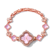A rose gold women's watch with a clover-shaped dial and matching clover-shaped links, embellished with pink crystals and clear rhinestones, shown on a white background with a NUOYA brand logo in the top left corner.