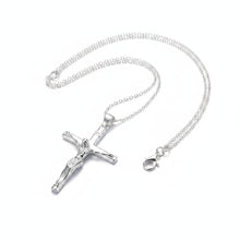 Silver necklace with a cross pendant on a light gray background