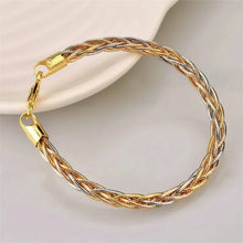 Gold and silver braided bracelet on a light background with 'GEEZENCA' branding.