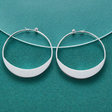 Silver hoop earrings on a teal fabric background with 'DOFEFFIL' branding.
