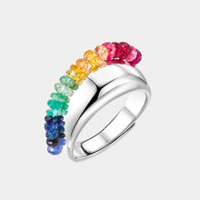 Silver ring with colorful gemstones on a white background, featuring the brand 'Geezenca'.