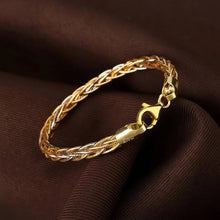 Gold braided bracelet on a brown fabric background with 'GEEZENCA' branding.