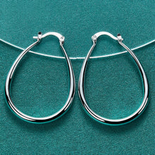 Silver hoop earrings on a teal background with 'DOVEFFIL' branding.