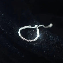 Silver bracelet on a dark background with 'GEEZENCA' branding.
