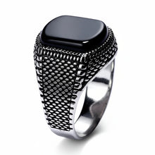 Silver ring with black stone on a white background, branded as GQ TORCH Fine Jewelry.