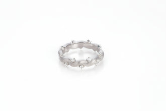 Silver ring with small stones on a white background